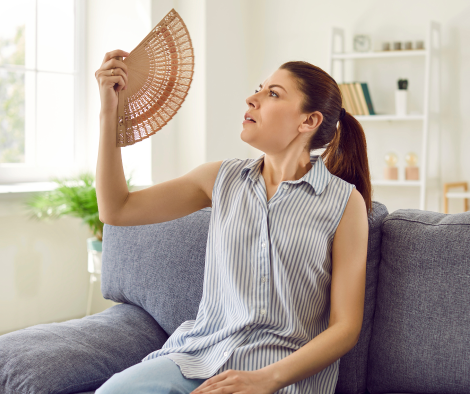 A woman fans herself in reaction to extreme heat