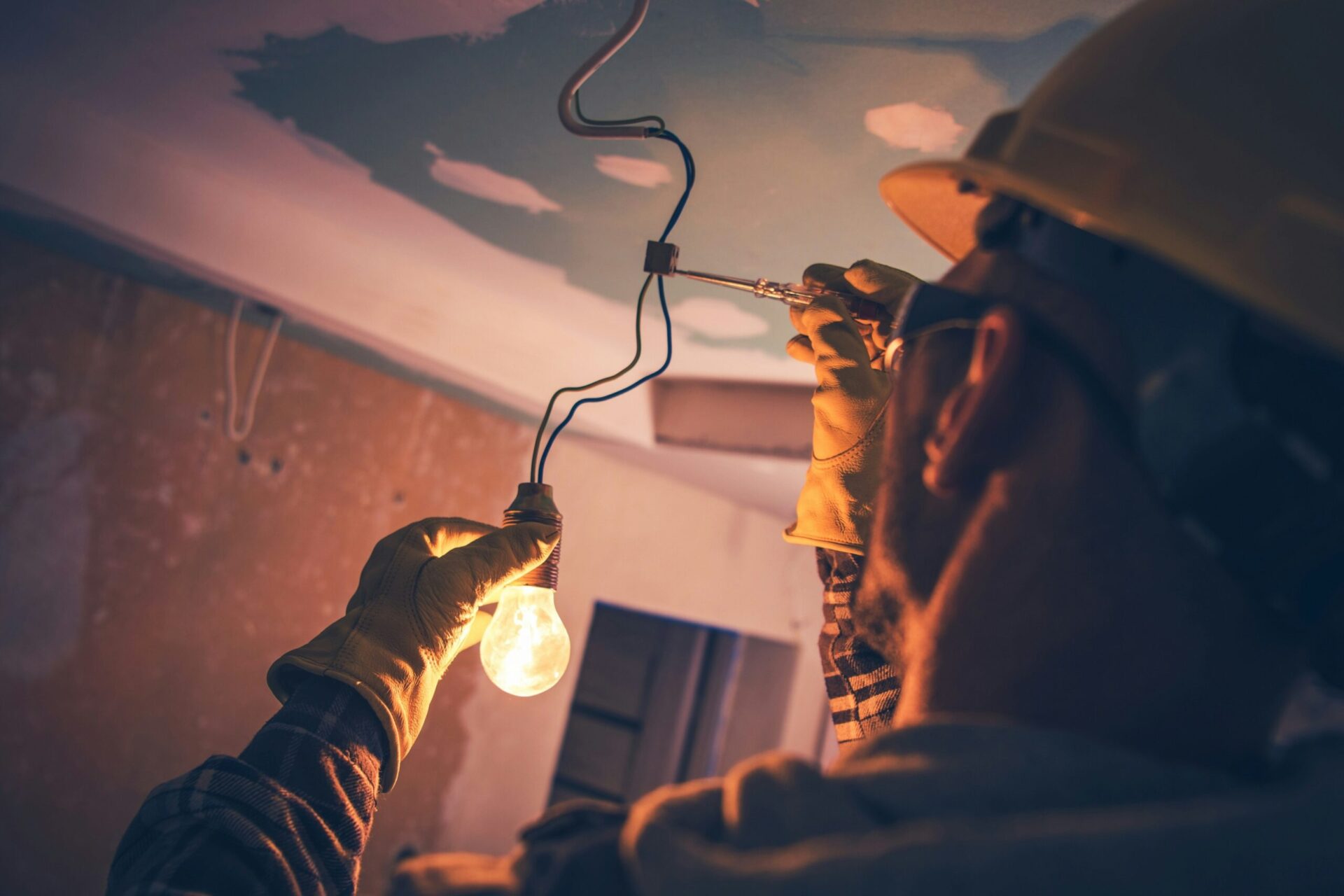 A technician repairs an electrical issue with a lightbulb